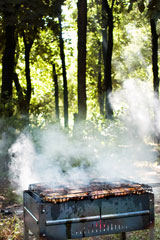 grilling steaks on a charcoal barbecue grill