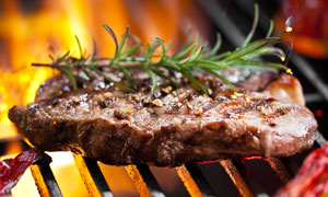 grilling steak on the barbie